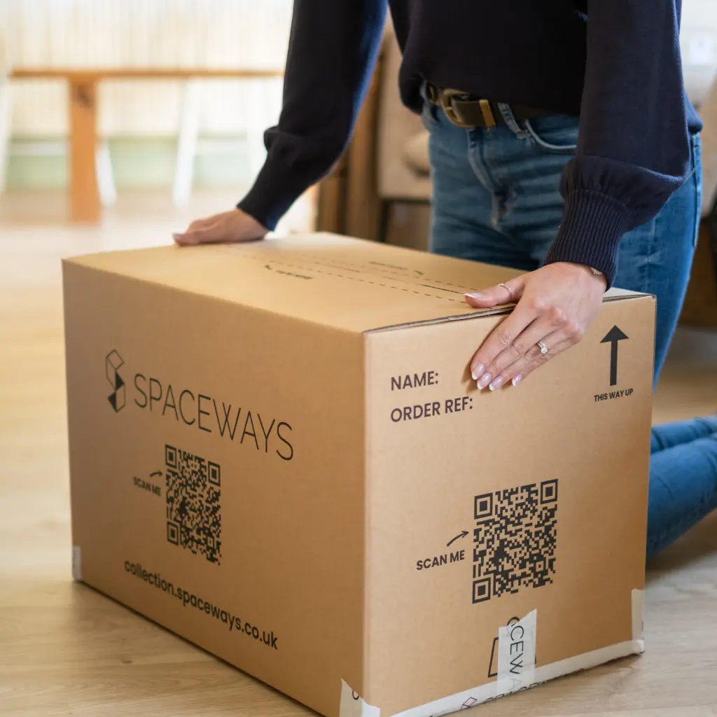 An image of a student using one of our Spaceways boxes to pack their storage into.